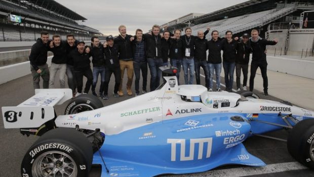 Members of TUM Autonomous Motorsport celebrate after winning Saturday's Indy Autonomous Challenge at IMS.