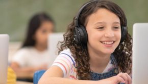 Digital Transformation - students using laptops and headphones in classroom