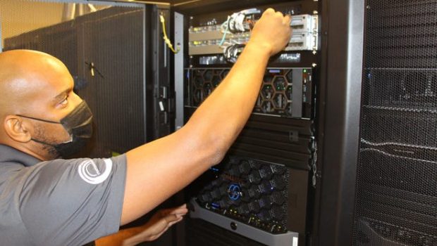 Network engineer Eric Arline performs routine maintenance on Palm Springs Unified School District servers on Oct. 11, 2021.