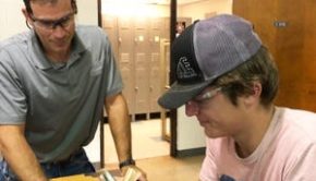 Energy and Power Instructor Jeff Littau assists a student with a wind turbine project.