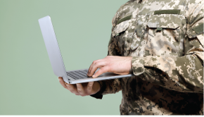uniformed servicemember on a laptop