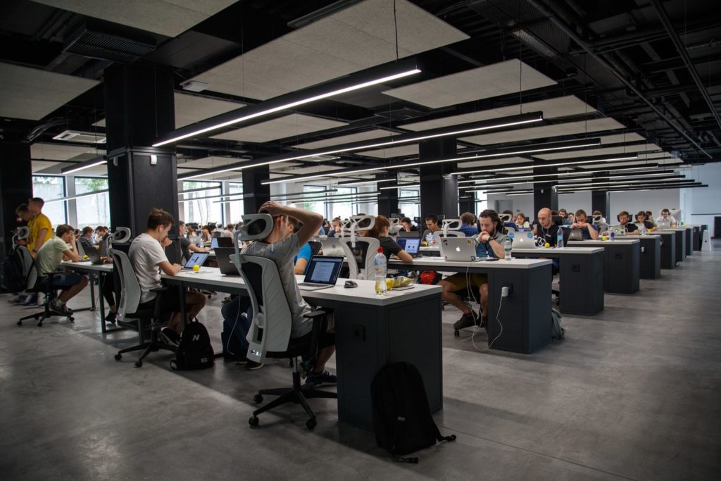 Image of an open-floor office with many employees working communally.