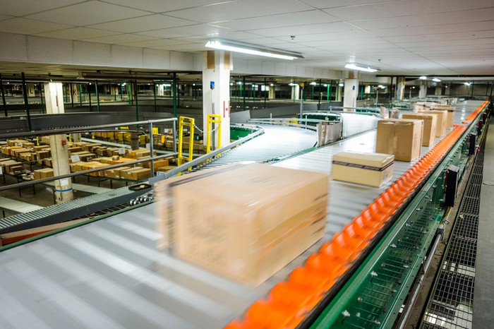 Ecommerce warehouse with packages moving on high speed conveyor.
