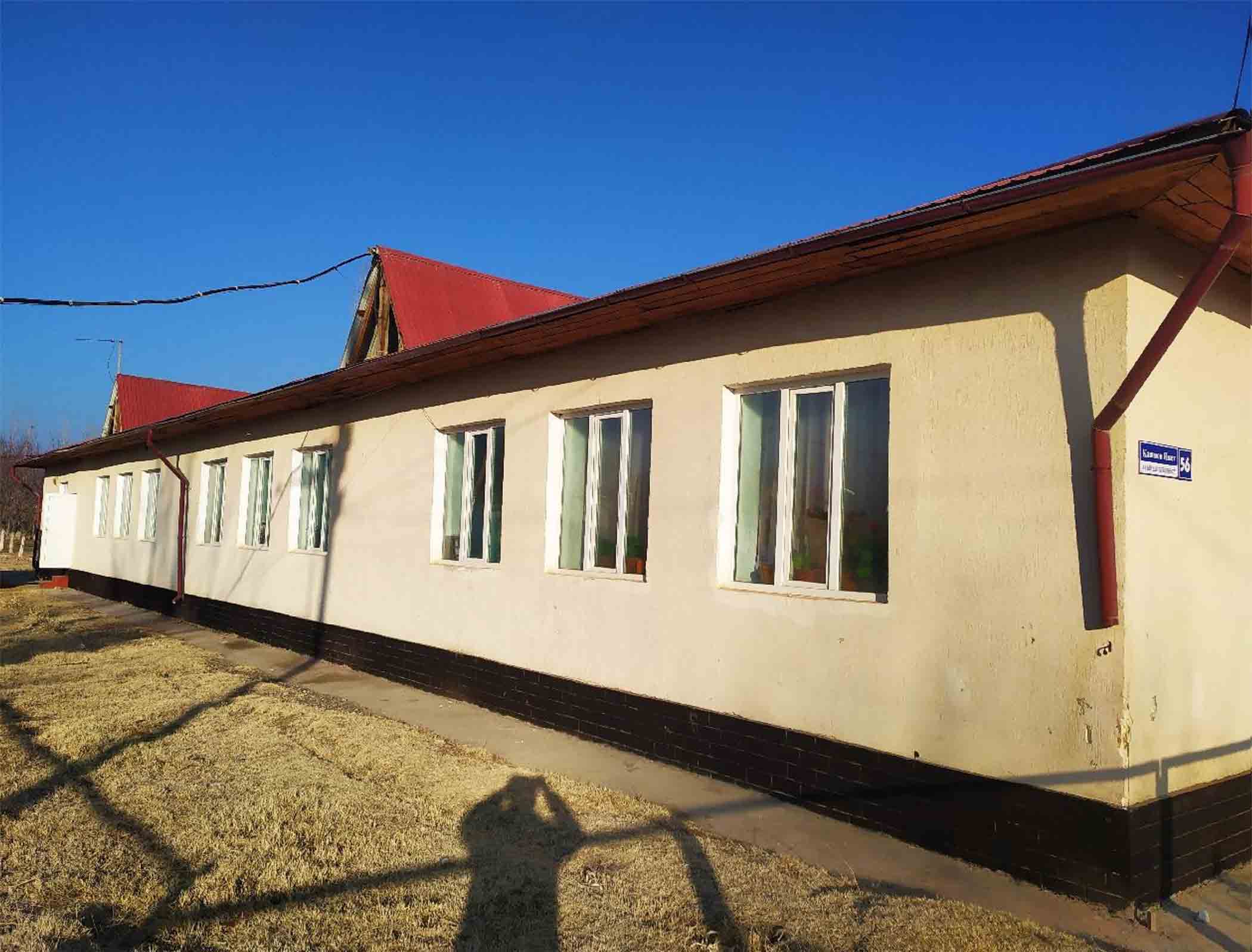 An official takes a photo of an undamaged school in the Kyrgyz Republic