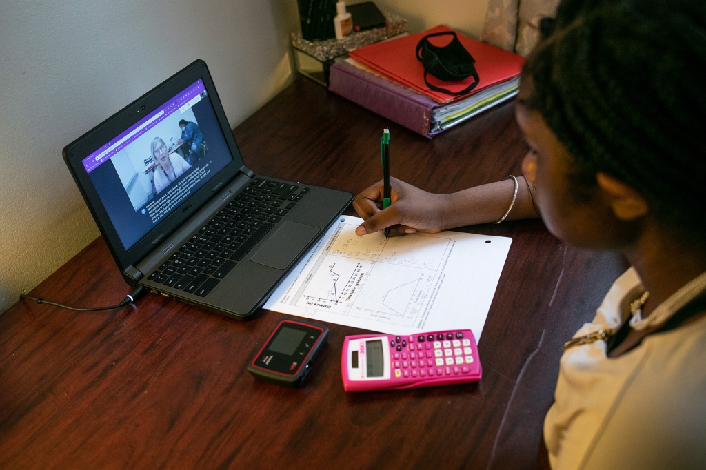 Abigail Previlon, 13, takes part in remote distance learning with her deaf education teacher Diane Gamse.