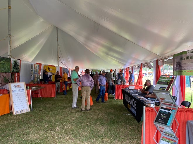 Farmers enjoy the vendor booths and offerings at the 32nd annual “Milan No-Till” Field Day.