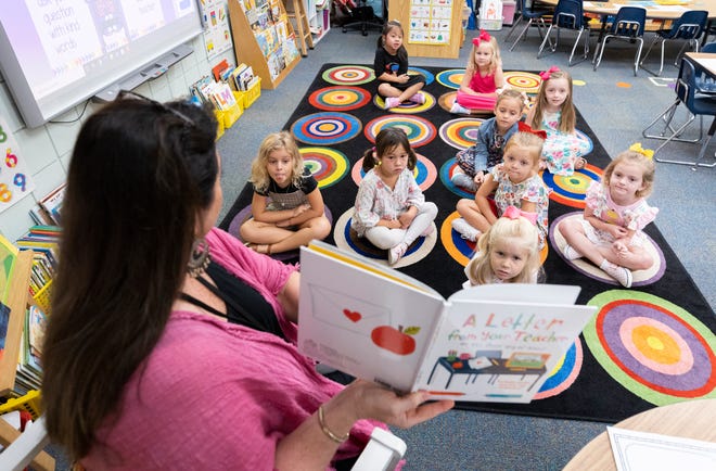 Patronis Elementary School welcomed back students for the first day of classes on Wednesday. Kindergarten teacher Cynthia Vines reads to her students on the first day of class.