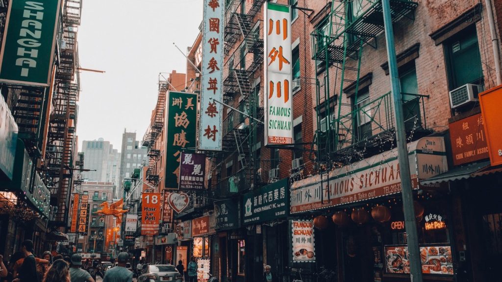Downtown New York City with Chinese lettering on street signs.