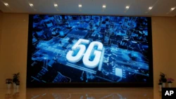 FILE - A 5G logo is displayed on a screen outside the showroom at the Huawei campus in Shenzhen city, in China's Guangdong province.
