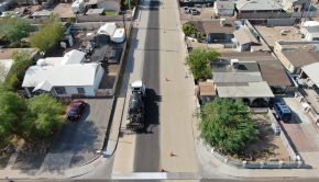 Drone photo of truck applying light gray coating to city street (Courtesy of City of Phoenix Street Transportation Department)