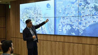 James Tan points to a map demonstrating how weather and water levels could be combined in JTC's digital twin to predict flooding