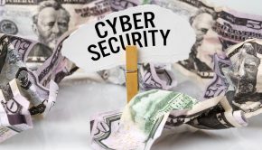 There are dollars on the table and there is a clothespin with paper on which it is written - CYBER SECURITY