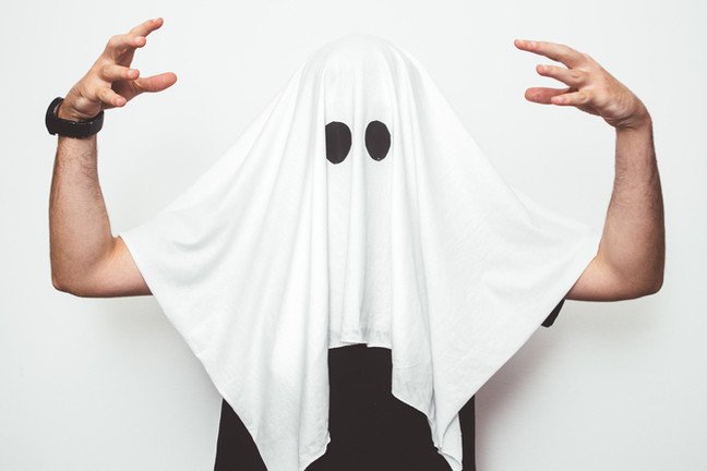 Man wearing ghost costume