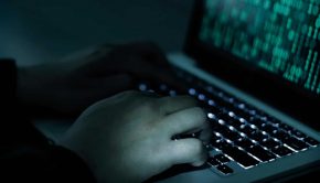 Hacker hands with binary codes on monitor showing the dark web
