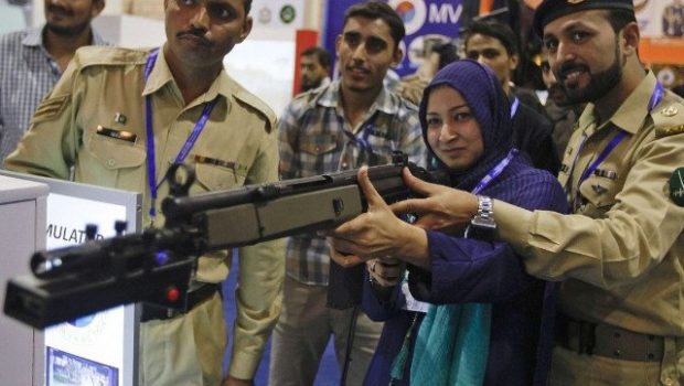 a visitor aims a simulation gun at a target during the international defence exhibition and seminar in karachi pakistan photo file reuters