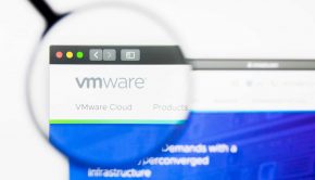Magnifying glass over VMware website showing security bug affecting VMware servers