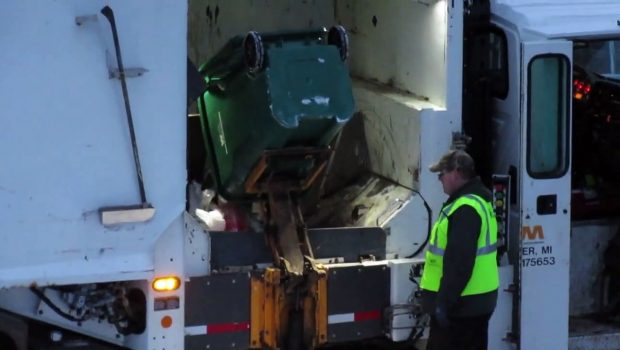 Side Loader Garbage Truck Collecting Garbage 12-31-2018