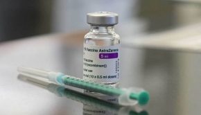A vial containing the Covid-19 vaccine by AstraZeneca and a syringe are seen on a table in the pharmacy of the vaccination center at the Robert Bosch hospital in Stuttgart, southern Germany.